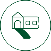 Green building icon on black background.