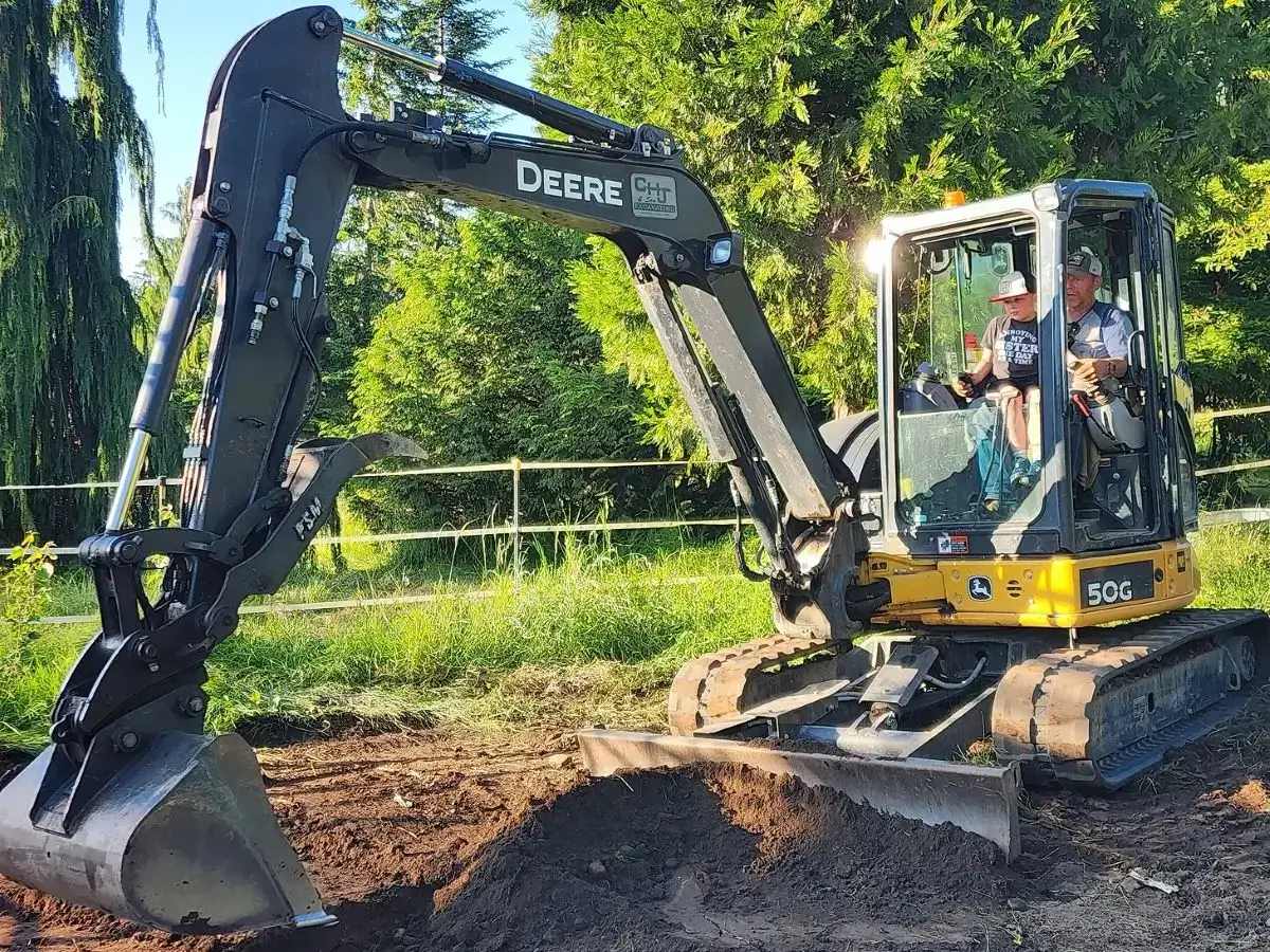 Mini John Deere excavator with adult and child