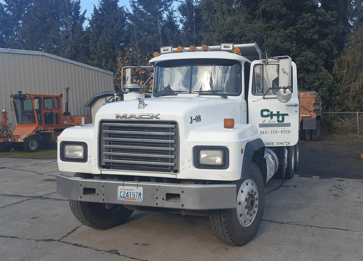 White Mack truck parked at a lot.